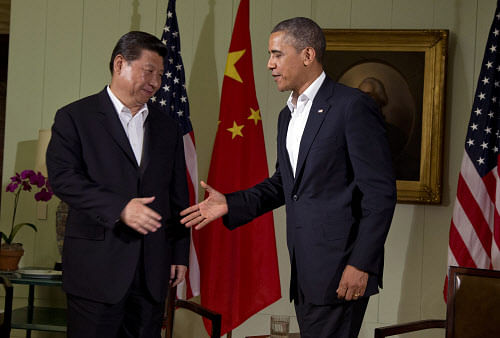 President Barack Obama, right, shakes hands with Chinese President Xi Jinping at the Annenberg Retreat at Sunnylands Friday, June 7, 2013, in Rancho Mirage, Calif. Seeking a fresh start to a complex relationship, the leaders are retreating to a sprawling desert estate for two days of talks on high-stakes issues, including cybersecurity and North Korea's nuclear threats. (AP Photo)