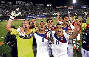 staying in the hunt: Chile players celebrate their win over Paraguay on Friday. AP