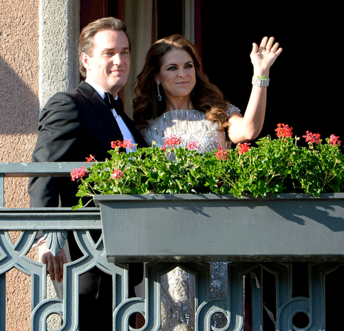 Christopher O'Neill, from the US, left, and Swedish Princess Madeleine, right, wave from the balcony of the Grand Hotel in Stockholm, Sweden, Friday June 7, 2013, prior to a dinner for the couple at the hotel, the day before their wedding. Three years ago she crossed the Atlantic with a broken heart. Now Sweden's 'party princess' returns from New York to Stockholm to tie the knot with her new, British-American love. On Saturday, Princess Madeleine - the Duchess of Halsingland and Gastrikland - will wed New York banker Christopher O'Neill in the Swedish capital, bringing together European royals and top New York socialites for a grand celebration. (AP Photo)