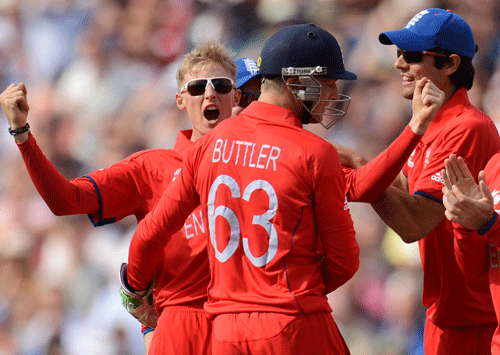 England's Joe Root (L) celebrates after dismissing Australia's Phillip Hughes during the ICC Champions Trophy Group A match against England at Edgbaston cricket ground in Birmingham June 8, 2013. REUTERS
