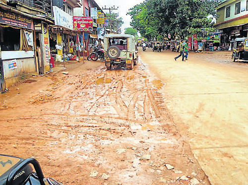 Public nuisance: Mud dumped on one side of the road in Car Street in Sullia has been causing inconvenience to the public. (Right) Asphalted road was dug on the very next day for fixing gate valve of the water pipe in Car Street in Sullia. dh photos