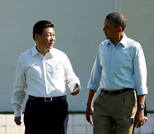 U.S. President Barack Obama and Chinese President Xi Jinping (L) walk the grounds at The Annenberg Retreat at Sunnylands in Rancho Mirage, California June 8, 2013. The two-day talks at a desert retreat near Palm Springs, California, was meant to be an opportunity for Obama and Xi to get to know each other, Chinese and U.S. officials have said, and to inject some warmth into often chilly relations while setting the stage for better cooperation. REUTERS