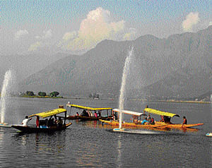 Tourists enjoy shikara ride in Dal Lake in Srinagar on Sunday. PTI