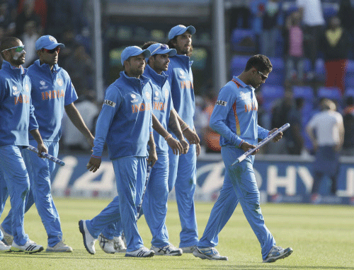 Ravindra Jadeja, right , holds a stumps as he walks off the pitch after India defeated South Africa in their group stage ICC Champions Trophy cricket match in Cardiff, Wales on June 6, 2013 AP Photo