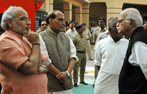 FILE - Senior BJP leader L K Advani with party president Rajnath Singh and Gujarat Chief Minister Narendra Modi in Ahmedabad. Advani resigned from all party posts on Monday, a day after Modi was appointed as chairman of the party's election campaign committee. PTI Photo