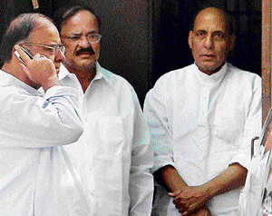 BJP President Rajnath Singh with senior leaders Arun Jaitley and Venkaiah Naidu after a meeting at his residence in New Delhi on Monday. PTI