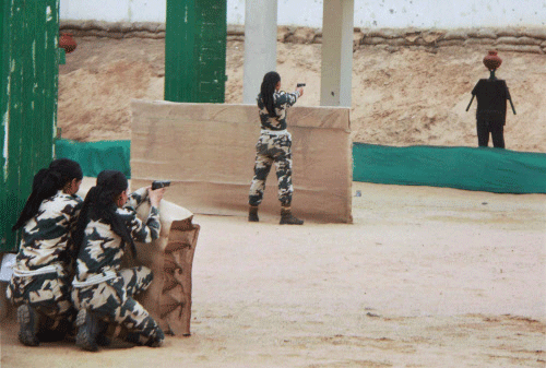 Female commando exhibitting their skills as the first batch of All Women Commando Team of CRPF passed out at Kadurpur Training Centre in Gurgaon on Tuesday. PTI Photo