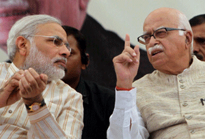 **FILE** File photo of senior BJP leader L K Advani with Gujarat Chief Minister Narender Modi at a public meeting in Bharuch in Nov 2011. Advani resigned from all party posts on Monday, a day after Narendra Modi became the party's campaign committee chief. PTI Photo