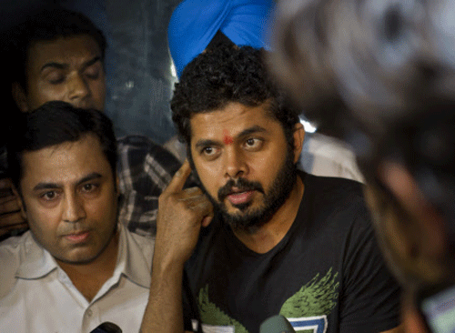Shantakumaran Sreesanth, center, who on May 16 was arrested along with two other players on spot fixing charges, talks to the media after he was released from prison in New Delhi, India, Tuesday, June 11, 2013. All three players were granted bail by a Delhi court on Monday. AP Photo