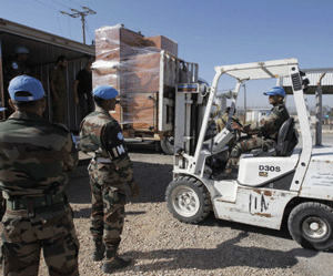 United Nations (U.N.) peacekeeping soldiers load a truck with furniture removed from the offices of Austrian U.N. troops based in the Syrian side of the Quneitra border crossing between Israel and Syria, on the Israeli-occupied in the Golan Heights June 11, 2013. Austria has begun withdrawing peacekeepers from the Golan Heights, winding down a four-decade mission due to spillover fighting from the Syrian civil war, the defence ministry said. REUTERS