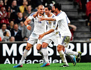 Party time: Armenia's Yura Movsisyan, Henrikh Mkhitaryar and Valeri Aleksanyan (from left) celebrate their win over Denmark in a World Cup qualifier in Copenhagen on Tuesday. AP