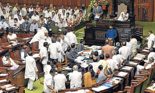 all is not well: Members of the BJP and the KJP stage a dharna in the well of the Legislative Assembly, opposing the Panchayat Raj Act Amendment Bill, on Wednesday. DH Photo