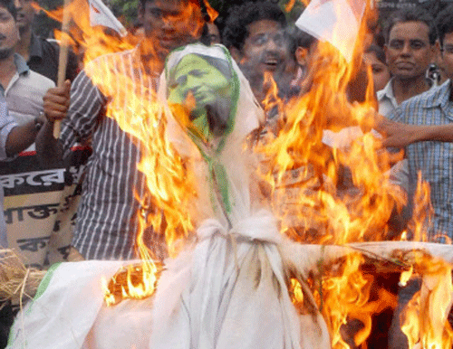 Members of Democratic Youth Federation of India (DYFI) and Students Federation of India (SFI) burn an effigy of West Bengal Chief Minister Mamata Banerjee during a protest rally against gangrape and murder of a 20-year-old student, in Kolkata on Wednesday. PTI Photo