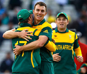 South Africa's Ryan McLaren, centre, celebrates the wicket of Pakistan's Junaid Khan, as South Africa win by 67 runs during an ICC Champions Trophy cricket match between Pakistan and South Africa at Edgbaston in Birmingham, England, Monday, June 10, 2013. AP Photo