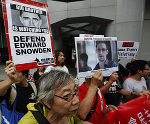 Protesters supporting Edward Snowden, a contractor at the National Security Agency (NSA), march to the U.S. Consulate in Hong Kong June 13, 2013. China's Foreign Ministry offered no details on Thursday on Snowden, the National Security Agency contractor who revealed the U.S. government's top-secret monitoring of phone and Internet data and who is in hiding in Hong Kong. REUTERS