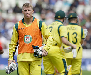FILE - This is a Wednesday, June 12, 2013 file photo of Australia's David Warner as he walks off the pitch after a drinks break as a non-playing reserve as his team play New Zealand during their group stage ICC Trophy cricket match at Edgbaston, Birmingham, England. Australia Thursday June 13, 2013 fined David Warner aus$11,500 ($11,000) and suspended the batsman up until the first Ashes test for attacking England player Joe Root in a bar. The opening batsman will miss Australia's final Champions Trophy match, against Sri Lanka on Monday, as well as the team's tour matches against Somerset and Worcestershire in the lead-up to the first test at Trent Bridge on July 10. Cricket Australia says Warner, who pleaded guilty to breaching its code of behavior, "will be eligible for selection for the first test." AP Photo