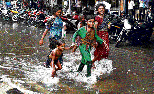 Happy showers: Children enjoy rain in Kolkata on Thursday. PTI