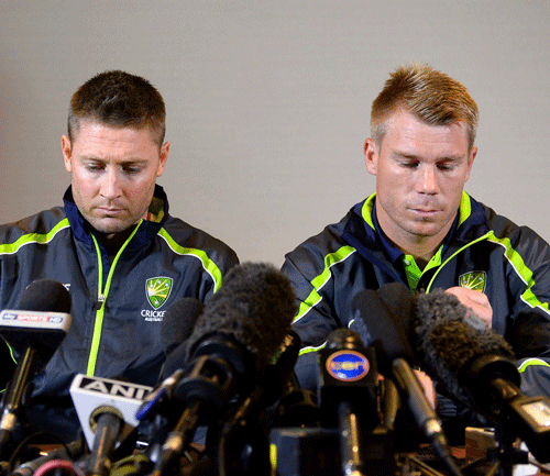 Michael Clarke (L) and David Warner speak to the media in London June 13, 2013. Australia batsman David Warner has issued an apology for getting involved in a late night bar-room fracas with young England player Joe Root. Earlier, the batsman was suspended until the first Ashes test on July 10 and fined 11,500 Australian dollars ($10,900) for his part in the incident which occurred in the early hours of Sunday in Birmingham after Australia's Champions Trophy defeat by England. REUTERS