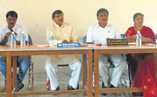MLA B B Ningaiah chairs a meeting in taluk panchayat in Mudigere on Friday. DH Photo