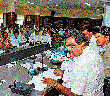 District-in-Charge Minister B Ramanath Rai chairing a review meet in DC office in Mangalore on Saturday. District-in-Charge Secretary Bharatlal Meena among others look on. DH&#8200;photo