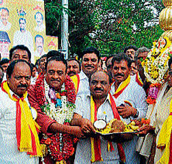 for Kannada: (Clockwise) Chairman of Kannada Sahitya Sammelana Maleyuru Guruswamy is felicitated before being taken on a procession. ZP president Ka Pu Siddaveerappa, Rajashekar Kadamba and others are seen.   dh photo