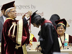 President Pranab Mukherjee presents Gold Medal to a student during first convocation of National Law University in New Delhi on Saturday. PTI Photo