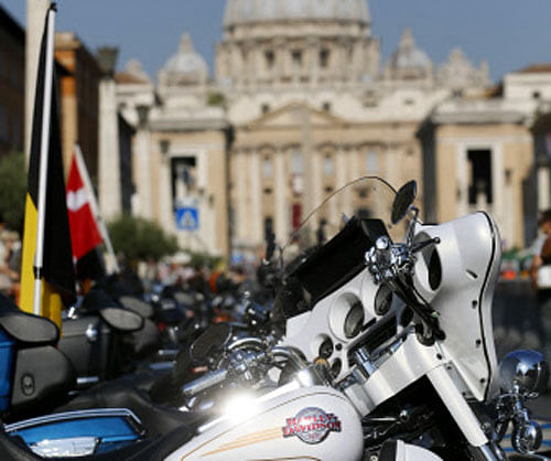 Harley-Davidson bikes are parked outside Saint Peter's Square before the start of a mass led by Pope Francis in Rome June 16, 2013. REUTERS.