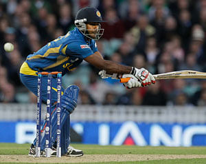 Sri Lanka' Nuwan Kulasekera plays and misses a ball bowled by England's James Anderson during their ICC Champions Trophy cricket match at the Oval cricket ground in London, Thursday, June 13, 2013. AP Photo