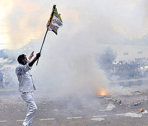 A Janata Dal-United worker burns crackers in celebration in Patna on Sunday. AP