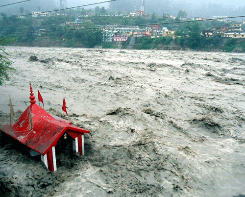 A temple submerged in flooded river Ganga due to heavy rains in Uttarkashi on Sunday. Thousands of Char Dham pilgrims were stranded on Gangotri and Yamunotri routes, as incessant overnight showers across Uttarakhand caused landslips in Uttarkashi district and swelled rivers. PTI Photo