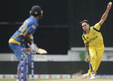 Australia's Mitchell Johnson bowls to Sri Lanka's Nuwan Kulasekara (left) during the ICC Champions Trophy group A match at The Oval cricket ground, London June 17, 2013. REUTERS