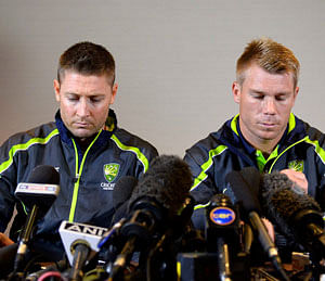 Australian cricket captain Michael Clarke (L) and David Warner speak to the media in London June 13, 2013. Australia batsman David Warner has issued an apology for getting involved in a late night bar-room fracas with young England player Joe Root. Earlier, the batsman was suspended until the first Ashes test on July 10 and fined 11,500 Australian dollars ($10,900) for his part in the incident which occurred in the early hours of Sunday in Birmingham after Australia's Champions Trophy defeat by England. REUTERS