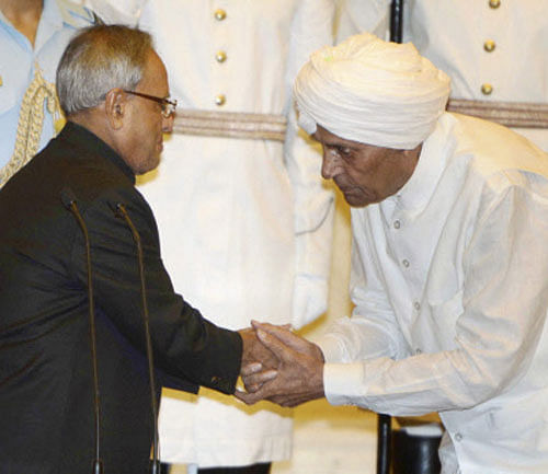 President Pranab Mukherjee greets newly inducted minister Sisram Ola after he took oath at a Swearing-in ceremony at Rashtrapati Bhavan in New Delhi on Monday. PTI Photo