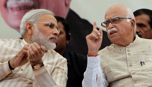 File photo of senior BJP leader L K Advani with Gujarat Chief Minister Narender Modi at a public meeting in Bharuch in Nov 2011. Advani resigned from all party posts on Monday, a day after Narendra Modi became the party's campaign committee chief. PTI Photo