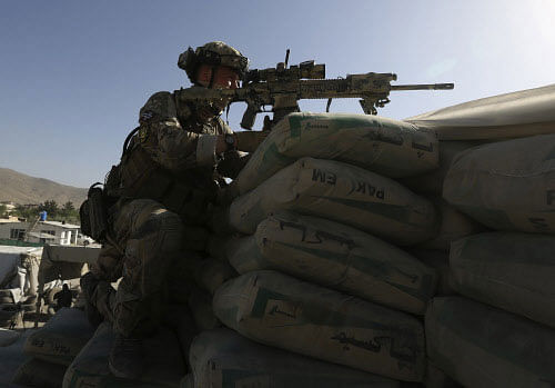 File image: A NATO soldier takes his position near the site of an attack in Kabul June 10, 2013. Insurgents launched the pre-dawn attack on Afghanistan's main international airport in the capital, Kabul, on Monday, police said, with explosions and gunfire heard coming from an area that also houses major foreign military bases. There were no immediate reports of casualties and there was also no early claim of responsibility for the attack. REUTERS