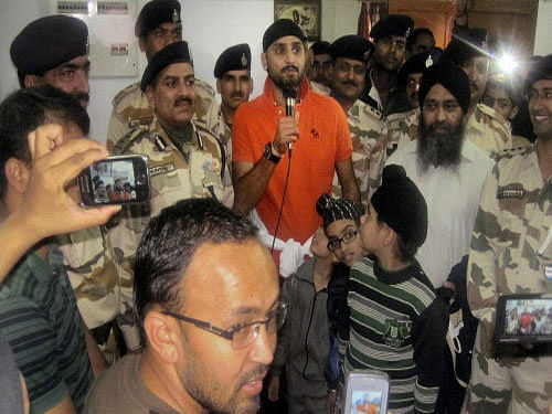 Cricketer Harbhajan Singh who was rescued by ITBP personnel on the way to Hemkund Sahib talks to media at a campt in Chamoli, Uttarakhand on Tuesday. Floods triggered by torrential rains have stranded many people in the state. PTI Photo