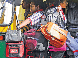 Defiant: Auto drivers continue to overload their vehicles despite the ruling. DH Photo by Dinesh S K