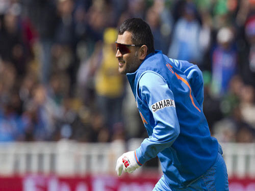 India's MS Dhoni reacts after catching Pakistan's Asad Shafiq for 41 off the bowling of Ishant Sharma during their ICC Champions Trophy cricket match at Edgbaston cricket ground, Birmingham, England, Saturday June 15, 2013. AP Photo