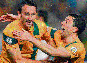 super sub: Australia's Josh Kennedy (left) celebrates with Tommy Oar after scoring the  winner during their World Cup Qualifier against Iraq in&#8200;Sydney on Tuesday. reuters