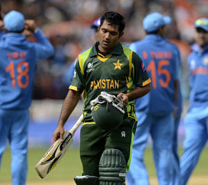 Pakistan's Asad Shafiq leaves the field after being dismissed during the ICC Champions Trophy group B match against India at Edgbaston cricket ground in Birmingham June 15, 2013. REUTERS