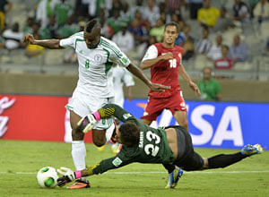 Nigeria's Brown Ideye is stopped by Tahiti goalkeeper Xavier Samin, right, during the soccer Confederations Cup group B match between Tahiti and Nigeria in Belo Horizonte, Brazil, Monday, June 17, 2013. AP Photo