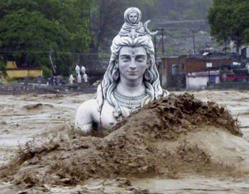 A submerged idol of Hindu Lord Shiva stands in the flooded River Ganges in Rishikesh on Tuesday. PTI Photo