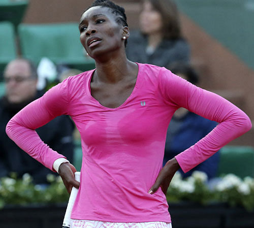 In this May 26, 2013, file photo, Venus Williams, of the United States, reacts after missing a return against Poland's Urszula Radwanska in their first round match of the French Open tennis tournament at Roland Garros stadium in Paris. Williams has pulled out of Wilmbledon because of a lower baback, her agent Carlos Fleming said, Tuesday, June 18, 2013. Williams, who turned 33 on Monday, was bothered by her back during a first-round loss at the French Open last month, (AP Photo/