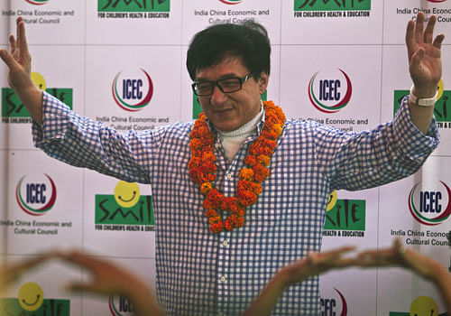 Hong Kong movie star Jackie Chan gestures during his visit at the non-governmental organization Smile Foundation in New Delhi, India, Wednesday, June 19, 2013. Chan interacted with children and taught them steps for self defense. (AP Photo