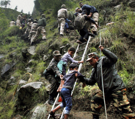 Army personnel rescue stranded children and other pilgrims to a safe place in flood-hit Govind Ghat in Chamoli, Uttarakhand on Tuesday. Floods triggered by torrential rains have stranded many people in the state. PTI Photo