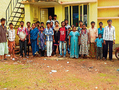 Victims of Thottilaguri in front of their temporary shelter, in Bajpe.