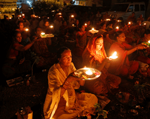 People carry oil lamps as they pray for the flood victims in the Himalayan state of Uttarakhand, outside a temple in the western Indian city of Ahmedabad June 19, 2013. Early monsoon rains have swollen the Ganges, India's longest river, swept away houses, killed at least 60 people and left tens of thousands stranded, officials said on June 18, 2013. REUTERS