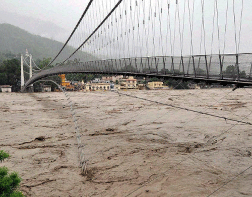 Ganga river water level flowing above the danger mark, at Ram Jhula in Rishikesh on Wednesday. PTI Photo