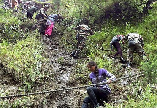 Army soldiers rescuing pilgrims during their flood relief operation in Chamoli, Uttarakhand. PTI Photo