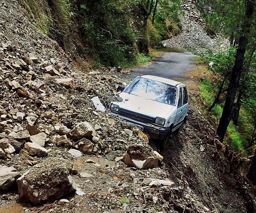 A car is abandoned in rubble from a landslide in Tehri, Uttarakhand. PTI Photo